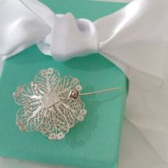 Fine details on this Sterling Silver Brooch.Marked 925 and AJS 83. AJS is a Thai jewelry Company.Roll closureWeighs 3.67g and measures 1.25" x 1.25"Comes in gift packaging. Elegant Brooches With Intricate Design For Gift, Flower Shaped Wedding Brooches Hallmarked, Wedding Flower Brooch Hallmarked, Wedding Flower Brooches Hallmarked, Flower Shaped Wedding Brooches, Elegant Silver Jewelry For Special Day, White Filigree Brooches For Wedding, White Filigree Wedding Brooches, Elegant White Filigree Brooches