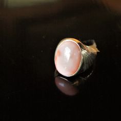 Gorgeous - classic and quality - mid century 1950s - heavy yellow gold signet ring style with large 20x14mm natural angel skin coral cabochon ring - marked and tested 585 / or 14k - weighs a hefty 8.9 grams and measures a US 10.5. Classic Oval Ring With High Luster, Classic Oval High Luster Ring, Classic Oval Rings With High Luster, Classic Pink Ring With Polished Finish, Vintage Opal Ring With Polished Finish For Formal Occasions, Classic Pink Cabochon Rings, Vintage Oval Dome Ring With Polished Finish, Vintage Dome Ring With Oval Cabochon Polished Finish, Vintage Dome Ring With Polished Oval Cabochon