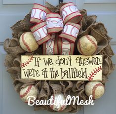 a wreath with baseballs and ribbons on it that says if we don't answer, we're at the ballfield