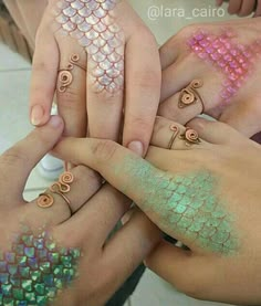 several people with different colored nail polishes on their hands