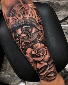 a person with a clock and rose tattoo on their arm