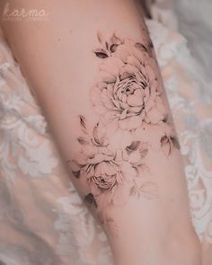 a woman's arm with flowers on it