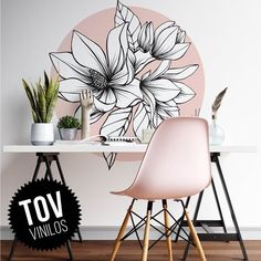 a white table with two chairs and a pink flower wall decal on the wall