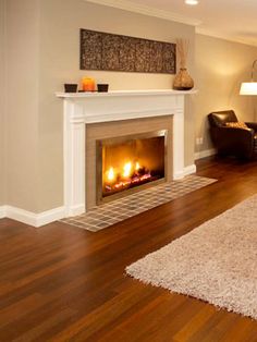 a living room filled with furniture and a fire place in the middle of the room