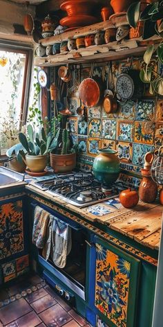 a kitchen filled with lots of pots and pans on top of a stove top oven