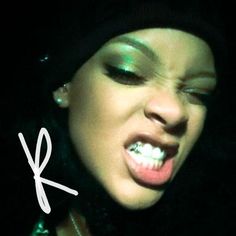 a close up of a person with her mouth open and tongue out in the dark