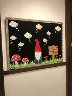 a bulletin board with an image of a gnome in the grass and mushrooms on it