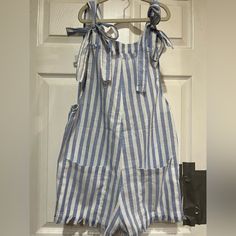 Cute Striped Romper With Pockets And Shoulder Bows For Adjustment. And Distressed Legs. New Never Worn Striped Cotton Jumpsuits And Rompers For Spring, Spring Vacation Cotton Overalls, Blue Overalls For Beach In Spring, Striped Overalls With Pockets For Summer, Striped Cotton Jumpsuits And Rompers For Day Out, Casual Striped Jumpsuits And Rompers For Day Out, Spring Striped Cotton Jumpsuits And Rompers, Striped Cotton Jumpsuits And Rompers For Beach, Striped Cotton Jumpsuit For Day Out