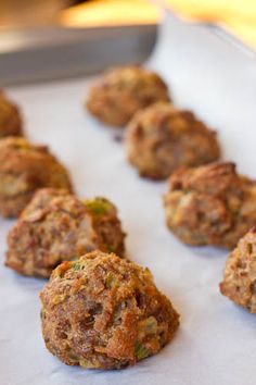 several balls of food sitting on top of a baking sheet