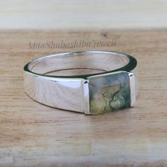 "Moss Agate Ring, Men's Ring, 925 Sterling Silver Ring, Wedding Ring, Emerald Cut Ring, Natural Moss Agate Jewelry, Anniversary Gift For Him SHOP LINK:- https://www.etsy.com/shop/MaaShabashibaJewell?ref=seller-platform-mcnav 》D E T A I L S《 Gemstone: Natural Moss Agate Gem Color: Green Gem Shape: Emerald Cut Gem Category: Cut Metal: 925 Sterling Silver Purity: 925 Parts Per 1000 Setting Type: Channel Silver Polish: High Ring Size: All Size Available Please note that there Can be slight variation Wedding Ring Emerald Cut, Wedding Ring Emerald, Silver Ring Wedding, Moss Agate Jewelry, Emerald Cut Ring, Ring Emerald Cut, Green Gem, Anniversary Gift For Him, Moss Agate Ring