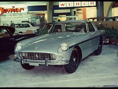 an old car is parked in a garage