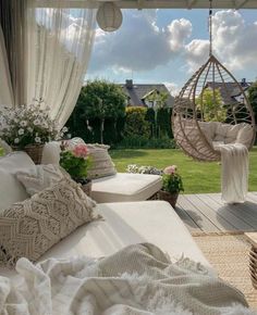 a white bed sitting on top of a wooden floor next to a lush green field