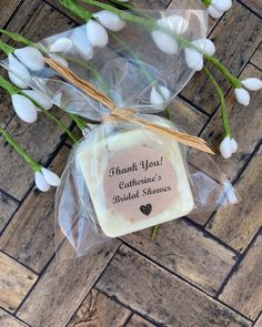 a soap bar wrapped in cellophane and sitting on top of a wooden floor