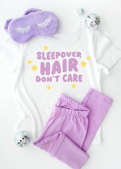 the sleepover hair don't care shirt and purple pants are next to an eye mask