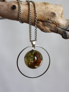 "A magnificent pendant made of real gifts of nature: moss, lichen, hazel cone in pure epoxy resin. The metal headband adds charm and emphasizes the beauty of the sphere. But you can get a pendant without a ring. Comes with a 45cm (18 \") silver plated chain. If you need a long metal chain, please indicate it in your message. I will gladly do it for you! A great gift for yourself or an important person! All jewelry comes in a box and is ready for a gift! When you are going to swim in the pool or Round Amber Resin Jewelry, Green Round Necklaces With Pressed Flowers, Resin Necklace With Natural Inclusions, Nature-inspired Jewelry With Natural Inclusions In Round Pendant, Nature-inspired Resin Round Pendant Jewelry, Green Pressed Flower Round Pendant Jewelry, Nature-inspired Moss Agate Jewelry With Natural Inclusions, Nature-inspired Round Resin Pendant Jewelry, Green Pressed Flowers Round Pendant Jewelry