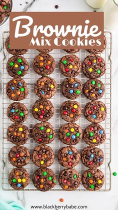 brownie mix cookies on a cooling rack with m & m candies in the middle