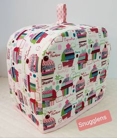 this is an image of a pink and green cake pattern cosmetic bag with the words sugglen's on it