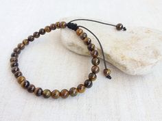 This Wrist Tasbih bracelet is made with 6mm Tigers eye beads. 33 beads used for dhikr and remembrance of Allah. Ideal gift for men or women. This bracelet is adjustable for wrist sizes between 7.5-9 inches. This tasbih has 8 inche inside diamete Tiger's Eye is known as a protective stone traditionally carried as a talisman against ill wishing and curses it shows to how to correctly use the power given to you. Tiger Eye assists in accomplishing goals, recognizing inner resources and urging clarit Adjustable Evil Eye Bracelet With Gemstone Beads, Adjustable Evil Eye Bracelet With 8mm Beads, Adjustable Brown Rosary Bracelet For Meditation, Tasbih Bracelet, Tigers Eye Bracelet, Accomplishing Goals, Prayer Bead Bracelet, Raw Crystal Necklace, Tiger Eye Bracelet