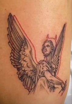 an angel tattoo on the back of a woman's leg