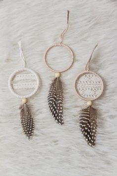 three dream catchers on a white fur background