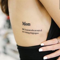 a woman with a tattoo saying mom on her back