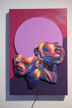 a painting on a wall with a purple circle in the background and two people's heads painted multicolored