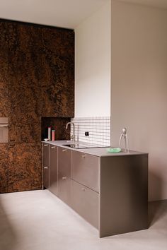 a modern kitchen with stainless steel cabinets and counter tops