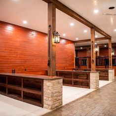 an empty room with benches and lights on the ceiling