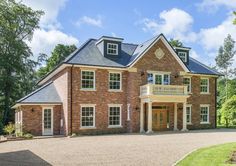 a large red brick house with white trim