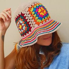 a woman wearing a colorful crocheted hat