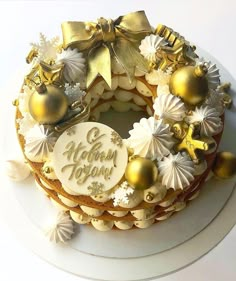 a cake decorated with gold and white decorations