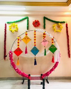 a circular display with colorful decorations hanging from it's sides and on the wall