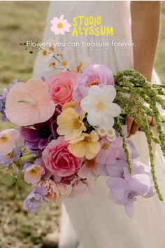 a woman holding a bouquet of flowers in her hand with the words true autumn above it