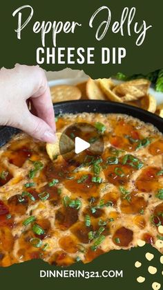 a hand dipping a tortilla chip into a bowl of pepper jelly cheese dip