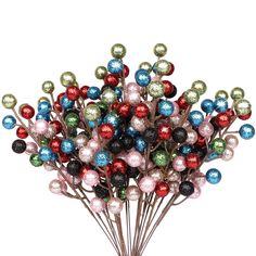 a bunch of christmas balls on top of each other in a vase with red, white and blue ornaments