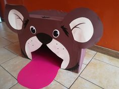 a paper cut out of a brown bear with its mouth open and tongue sticking out