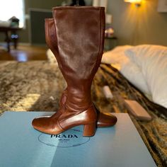 Like New Prada Brown Boots - Only Worn Once - Purchased From Neiman Marcus In 2017 For $1200.00 Price Is On Label - Paperwork Attached With Original Prada Box. Leather Boots With Padded Low Heel, Designer Calf Leather Boots With Padded Heel, Leather Almond Toe Boots With Medium Fit, Elegant Cognac Calf Leather Boots, Designer Business Boots With Leather Lining, Designer Leather Lined Boots For Business, Luxury Leather Square Toe Boots, Luxury Leather Boots With Square Toe, Italian Leather Boots For Galas