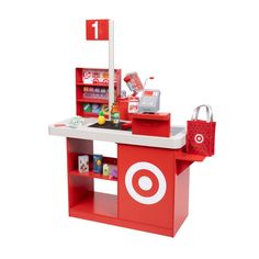 a play kitchen with red and white accessories on it's counter top, including a target sign