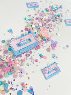 confetti and streamers are scattered around an old fashioned cassette player