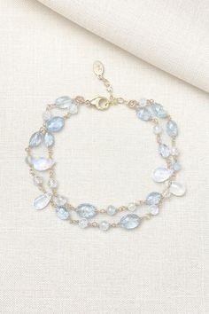 This bracelet showcases delicate moss aquamarine gemstones paired with radiant rainbow moonstones, creating a lovely, feminine style. The artisan meticulously hand-wire-wraps each gemstone bead, creating a beautiful, double-layered chain. The lobster claw clasp and extender chain allow for an adjustable fit. Bracelet length: 7 inches plus 1-inch extender chain Materials: aquamarine, rainbow moonstone, gold fll Elegant Hand Wrapped Moonstone Jewelry, Dainty Blue Moonstone Jewelry, Elegant Hand-wrapped Moonstone Jewelry, Elegant Aquamarine Beaded Bracelets With Natural Stones, Elegant Moonstone Gemstone Beaded Bracelets, Elegant Aquamarine Bracelets With Natural Stones, Handmade Aquamarine Bracelet, Aquamarine Gemstone Beaded Bracelets, Handmade Adjustable Aquamarine Bracelet