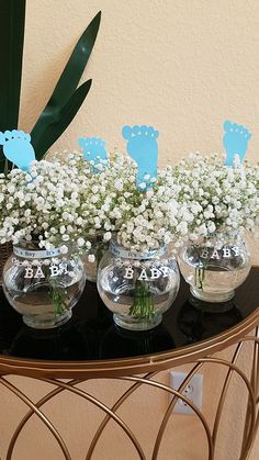 there are baby's breath flowers in vases on the table with blue ones