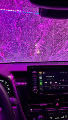 the interior of a car with purple lights on it's dash board and dashboard