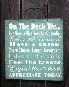 a sign that says on the deck we gather with friends and family