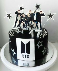 a black and white birthday cake with stars on the top that says bt's