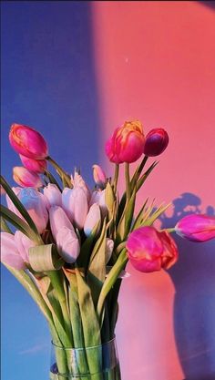 a vase filled with lots of pink and white flowers