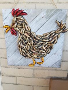 a chicken made out of wood sitting on top of a wall