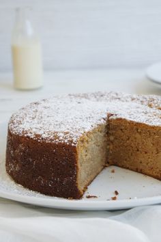 a cake on a plate with one slice cut out