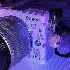 a camera with a hello kitty keychain attached to it