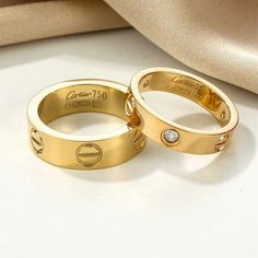 two gold wedding rings with diamonds on them