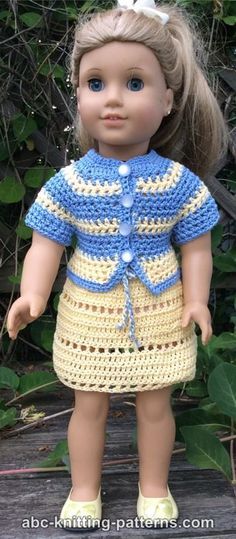 a doll wearing a crocheted dress and yellow shoes